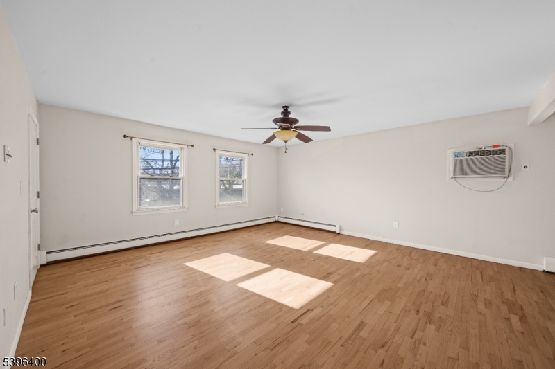 136 Clifton Boulevard Clifton, NJ 07011 - Photo 3 of 16 wooden floor in an empty room with a window