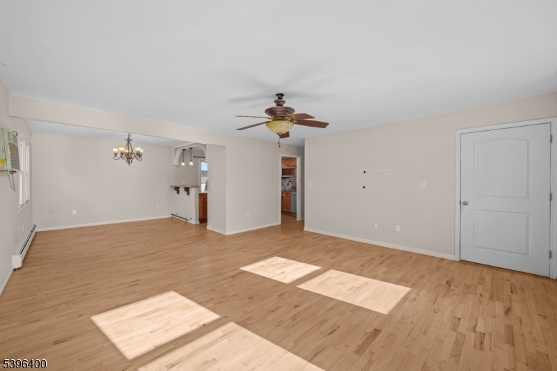 136 Clifton Boulevard Clifton, NJ 07011 - Photo 4 of 16 a view of a room with wooden floor and ceiling fan