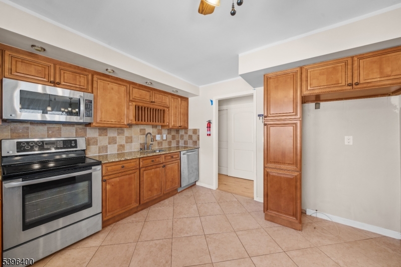 136 Clifton Boulevard Clifton, NJ 07011 - Photo 6 of 16 a kitchen with stainless steel appliances granite countertop a refrigerator and stove
