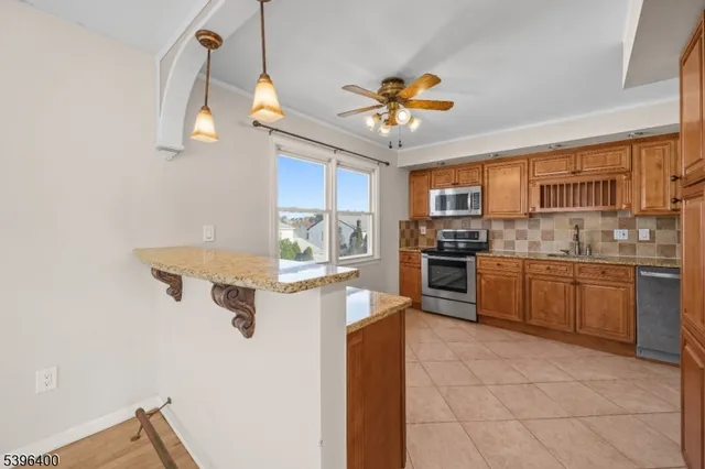 a kitchen with a refrigerator a stove top oven a sink and dishwasher