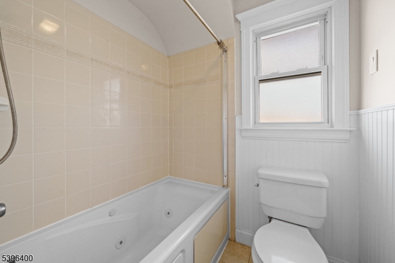 136 Clifton Boulevard Clifton, NJ 07011 - Photo 10 of 16 a white toilet sitting next to a bathroom sink and tub