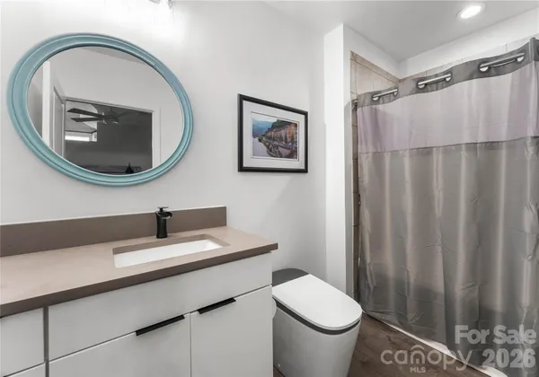 a bathroom with a toilet a sink and a mirror