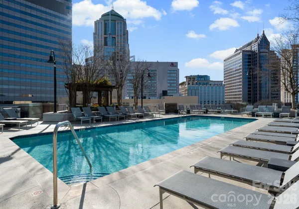 a swimming pool with outdoor seating and yard
