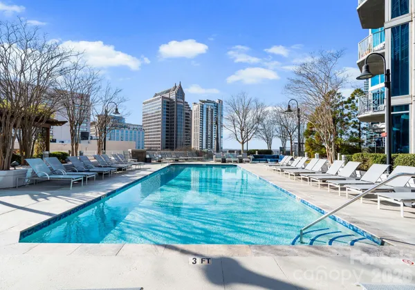 a view of swimming pool with outdoor seating and plants