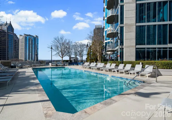 a swimming pool with outdoor seating and yard