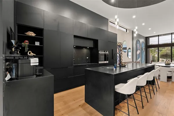 a kitchen with a table chairs refrigerator and microwave