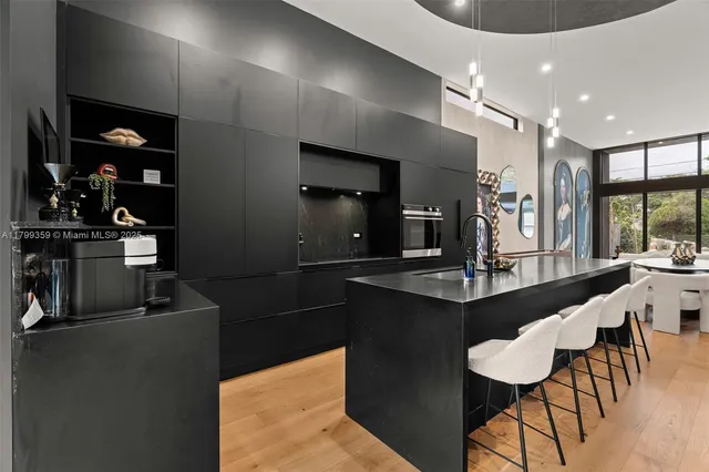 a kitchen with a table chairs refrigerator and microwave