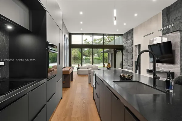 a kitchen with counter top space and windows