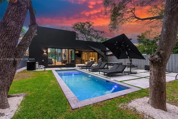 a view of a backyard with swimming pool