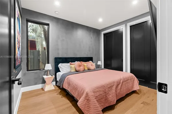 a bedroom with a bed and large mirror