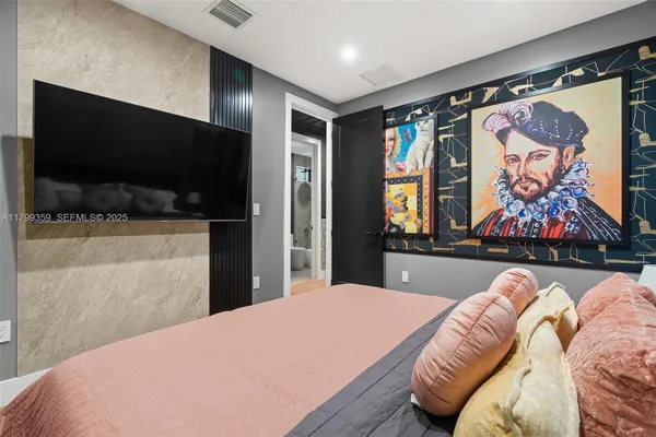 a bedroom with a bed and glass wall