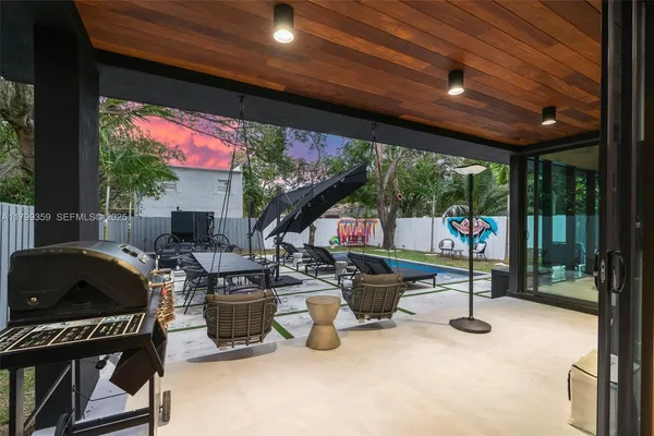 a view of a patio with a table and chairs