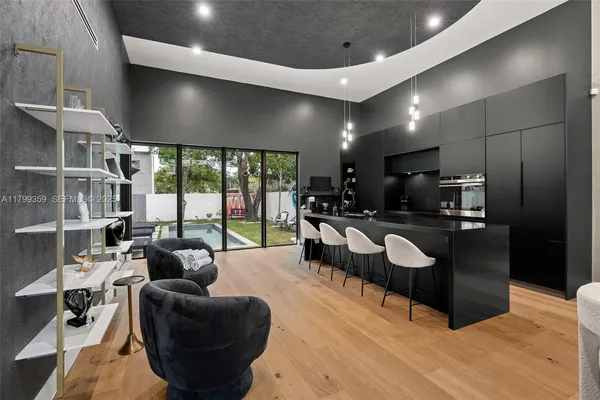 a living room with furniture a large window and flat screen tv