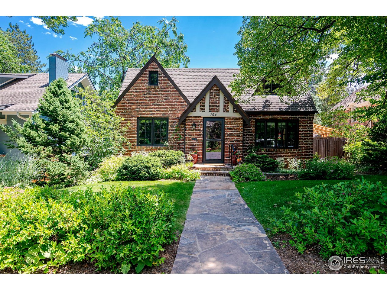 764 14th Street Boulder, CO 80302 - Photo 1 of 40 a front view of a house with a yard