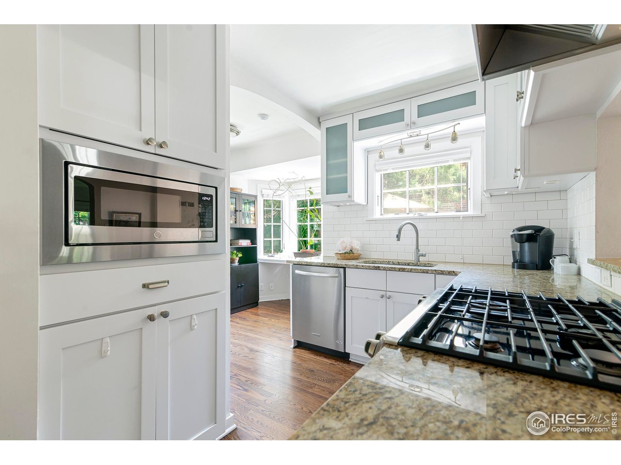 764 14th Street Boulder, CO 80302 - Photo 10 of 40 a kitchen with a stove and white cabinets