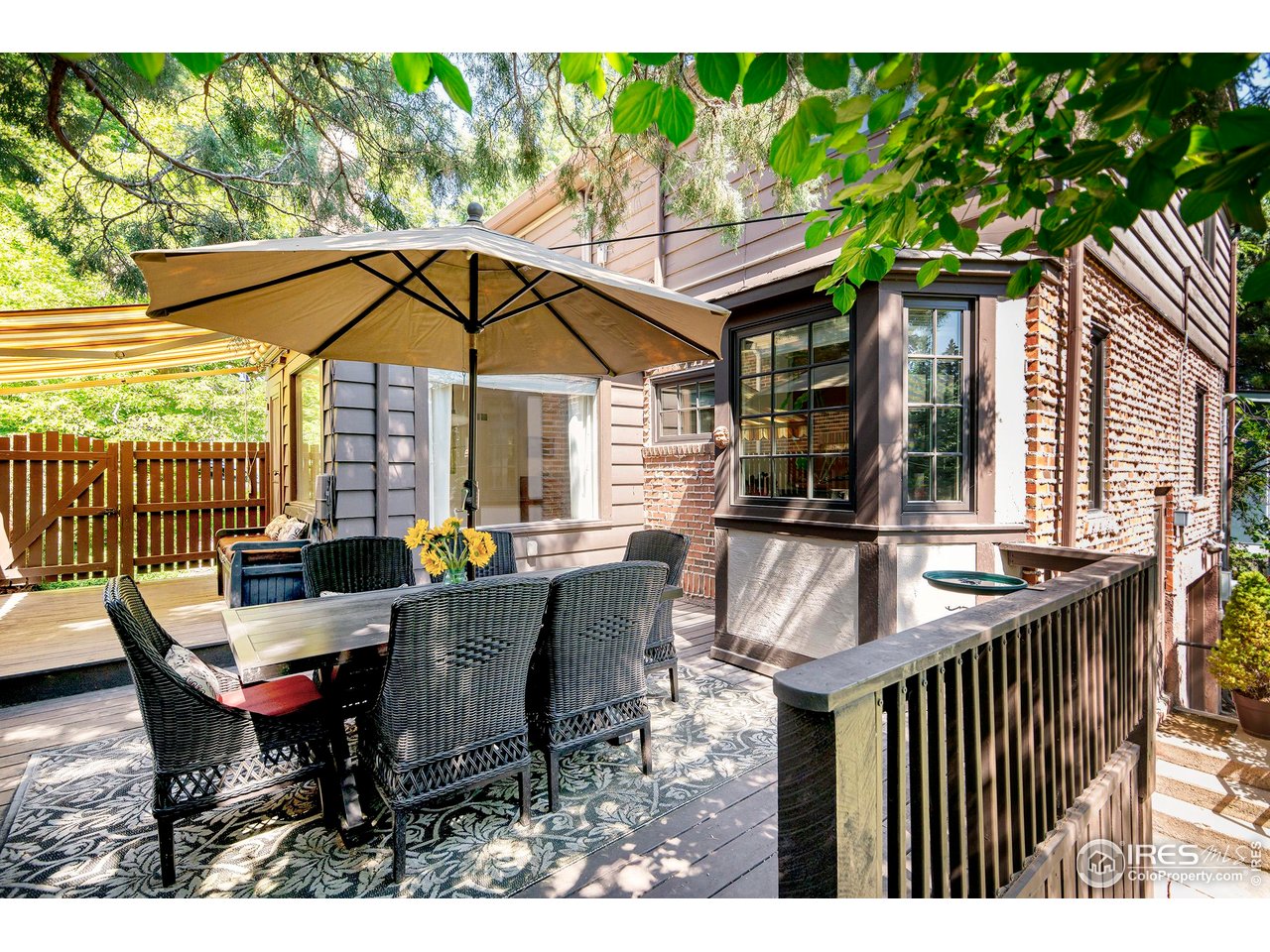 764 14th Street Boulder, CO 80302 - Photo 14 of 40 a view of a patio with table and chairs under an umbrella