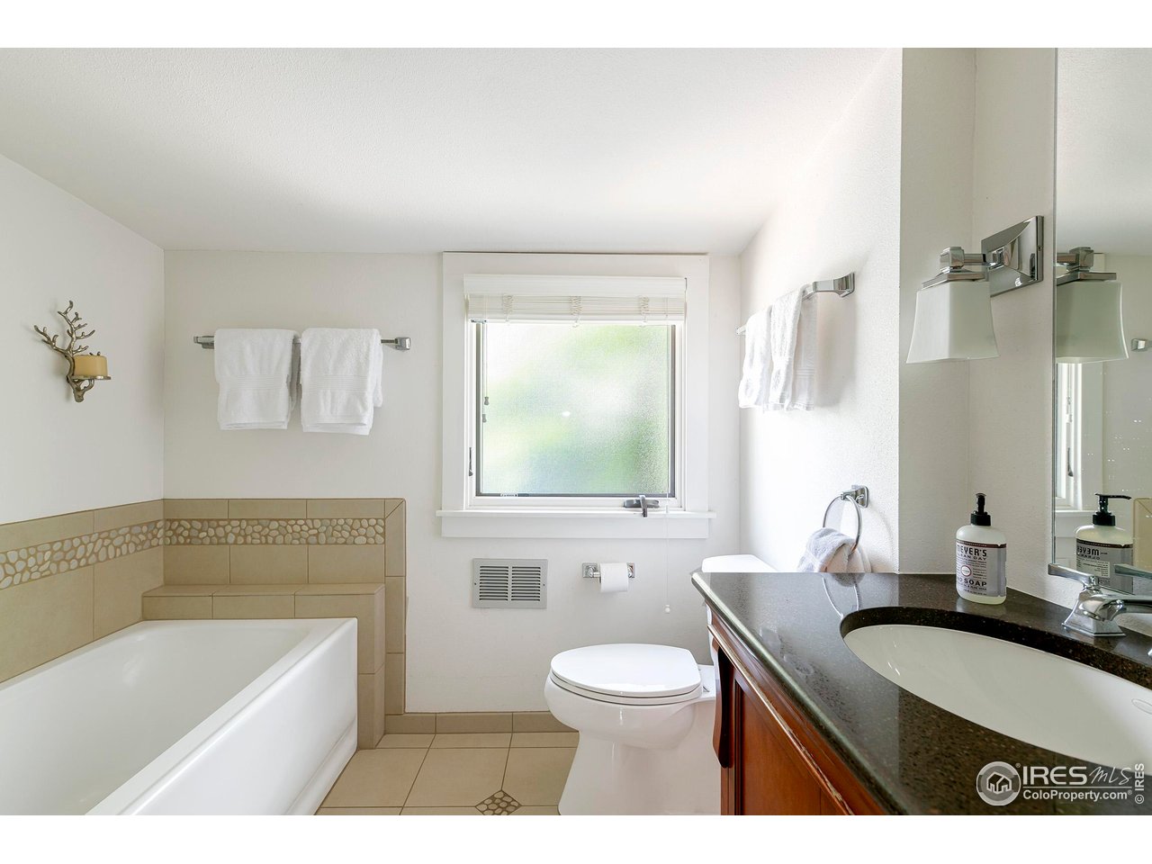 764 14th Street Boulder, CO 80302 - Photo 31 of 40 a bathroom with a sink a toilet a mirror and bathtub