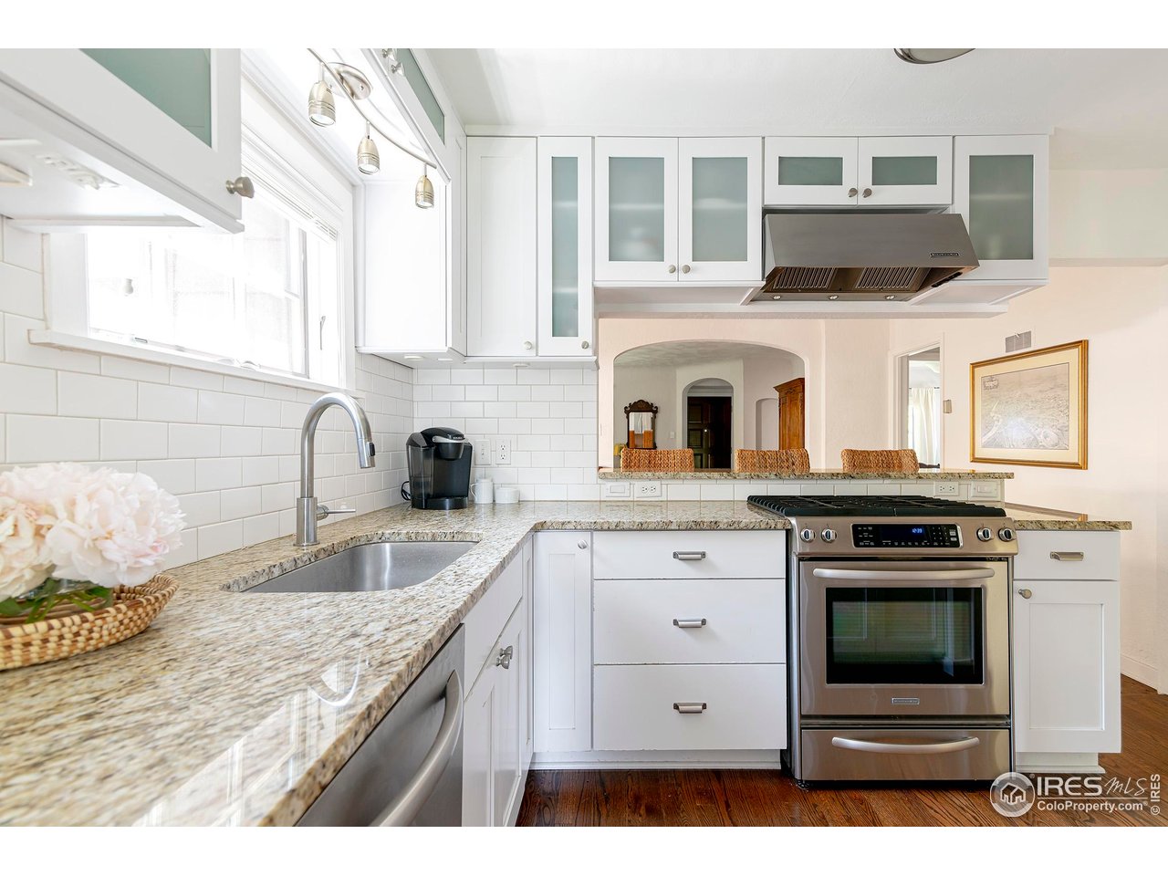 764 14th Street Boulder, CO 80302 - Photo 9 of 40 a kitchen with kitchen island granite countertop a stove and a sink