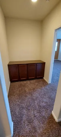 a view of an empty room and stairs