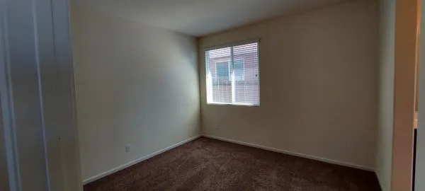 en empty room with windows and fan