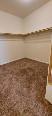a view of a room with wooden floor and a window