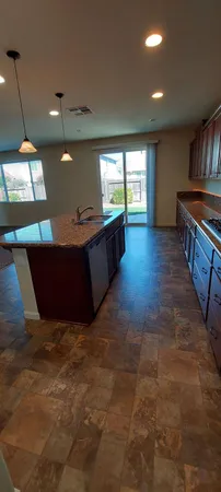a open kitchen with kitchen island a sink a stove and a window