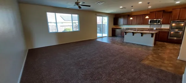 a kitchen with stainless steel appliances granite countertop wooden cabinets a sink and dishwasher