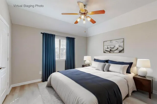 a bedroom with a large bed and a ceiling fan