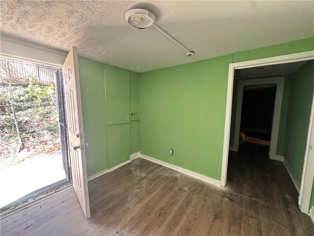 1292 Ralph David Abernathy Boulevard Atlanta, GA 30310 - Photo 16 of 16 an empty room with wooden floor and windows