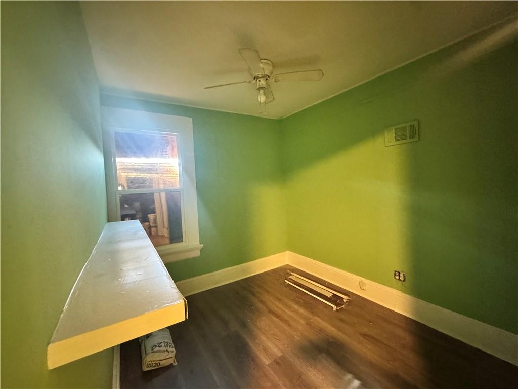 1292 Ralph David Abernathy Boulevard Atlanta, GA 30310 - Photo 2 of 16 a view of a room with wooden floor and a ceiling fan