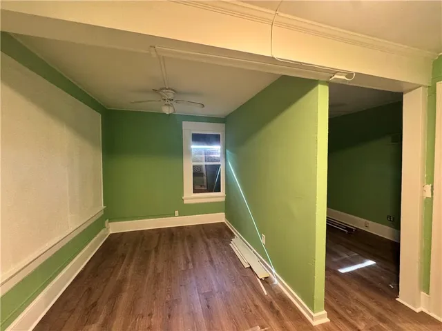 a view of a room with wooden floor and a window