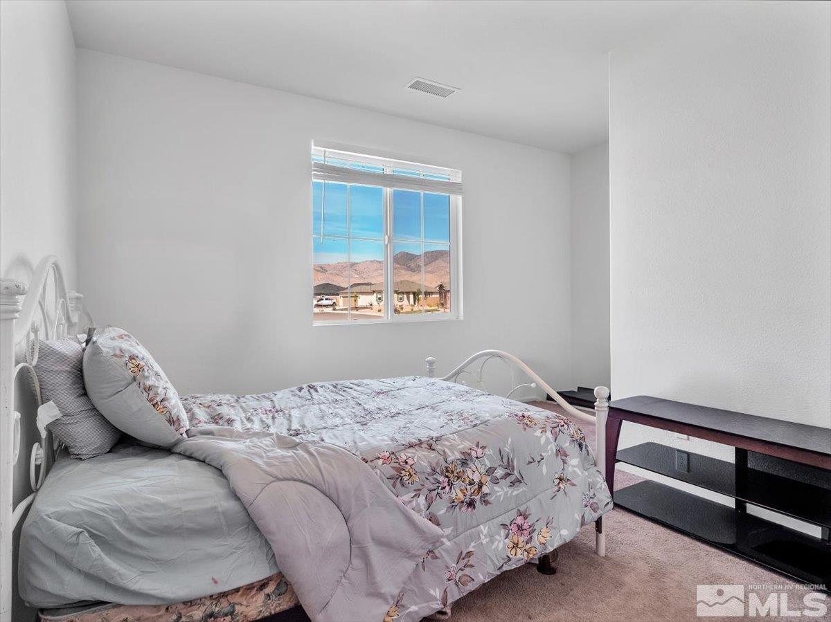 119 Oakmont Drive Dayton, NV 89403 - Photo 13 of 19 a bedroom with a bed and a window