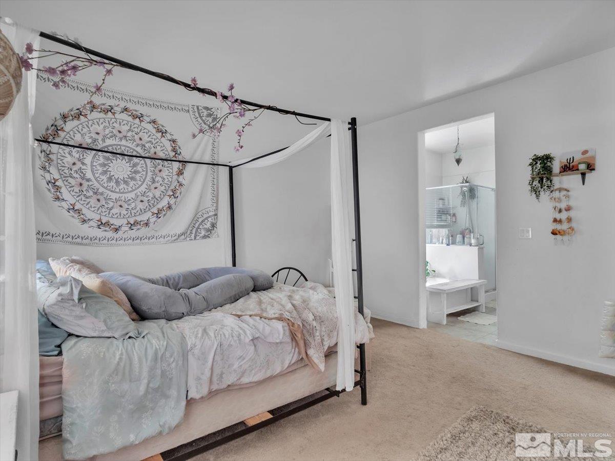 119 Oakmont Drive Dayton, NV 89403 - Photo 9 of 19 a bedroom with a bed couch and window