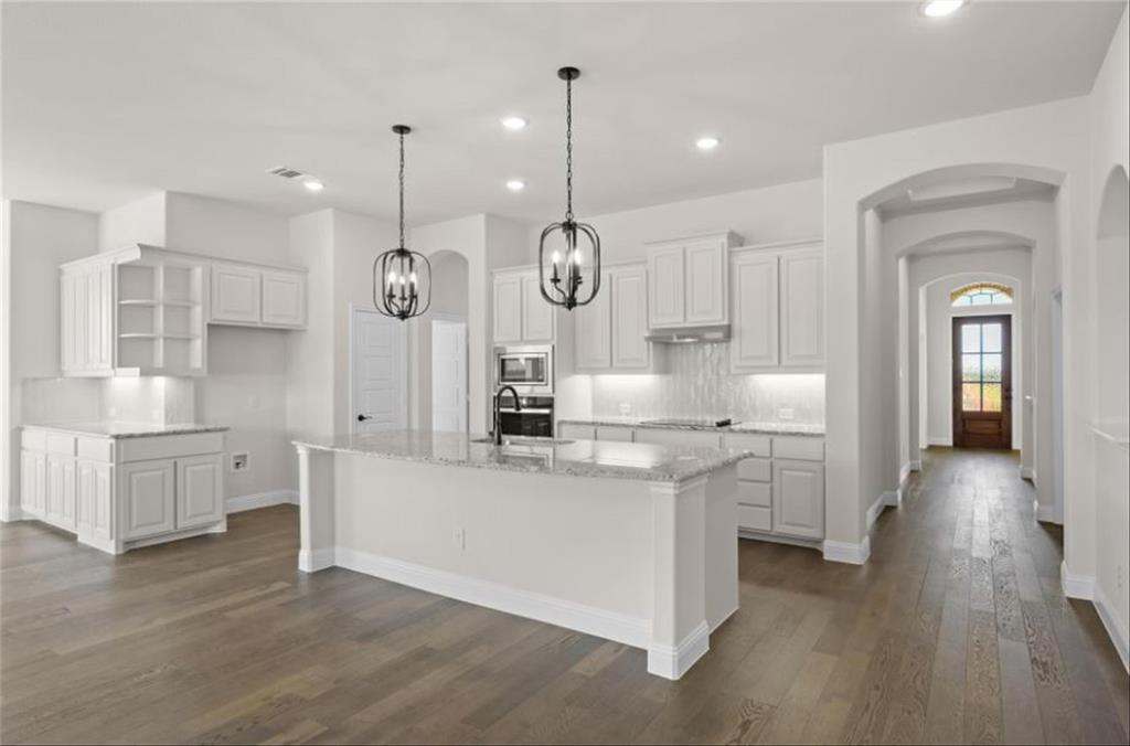 a very nice looking room with kitchen island furniture and a wooden floor