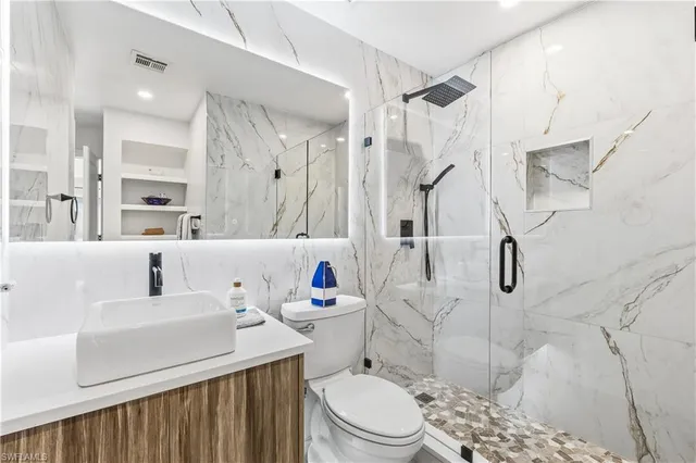a bathroom with a sink toilet and shower