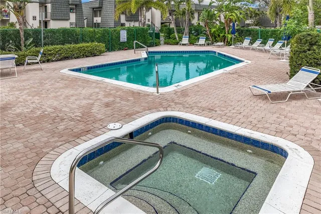 a swimming pool with outdoor seating yard and trees