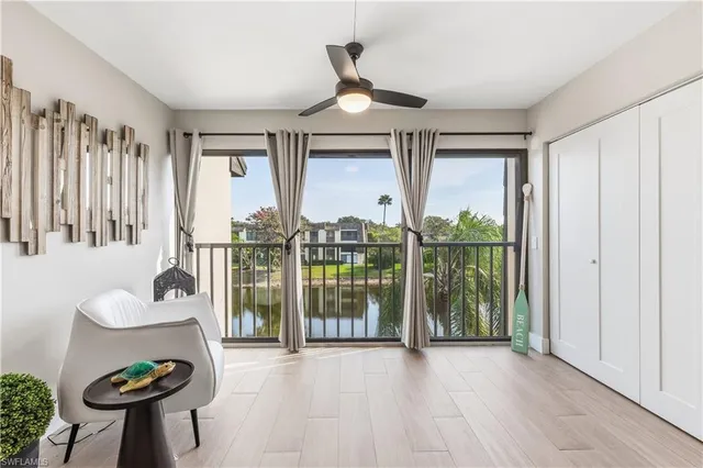 a very nice looking room with a large window and furniture