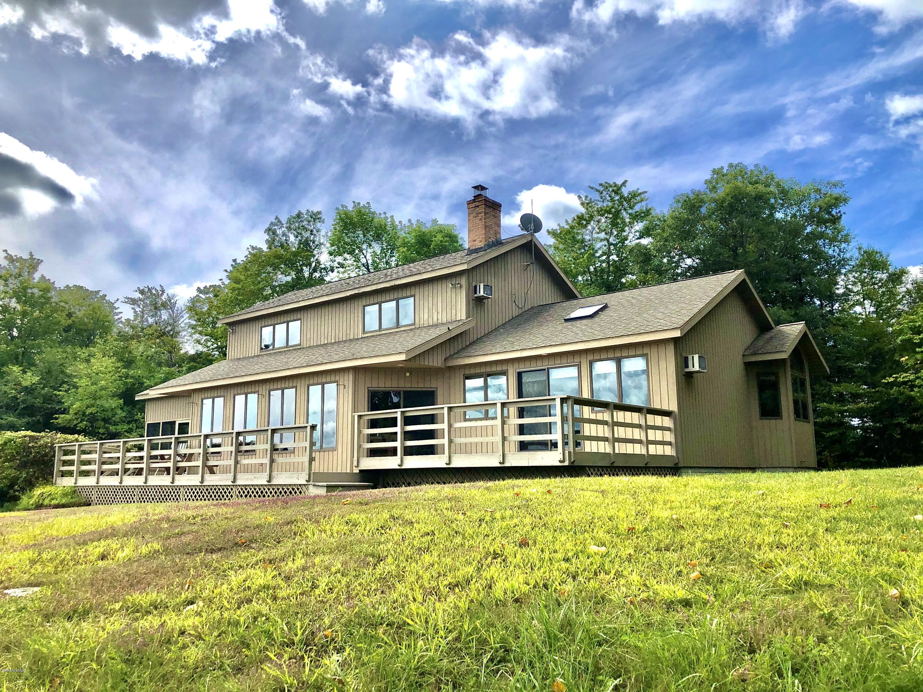 359 Harrington Road Otis, MA 01253 - Photo 1 of 60 a front view of a house with a garden