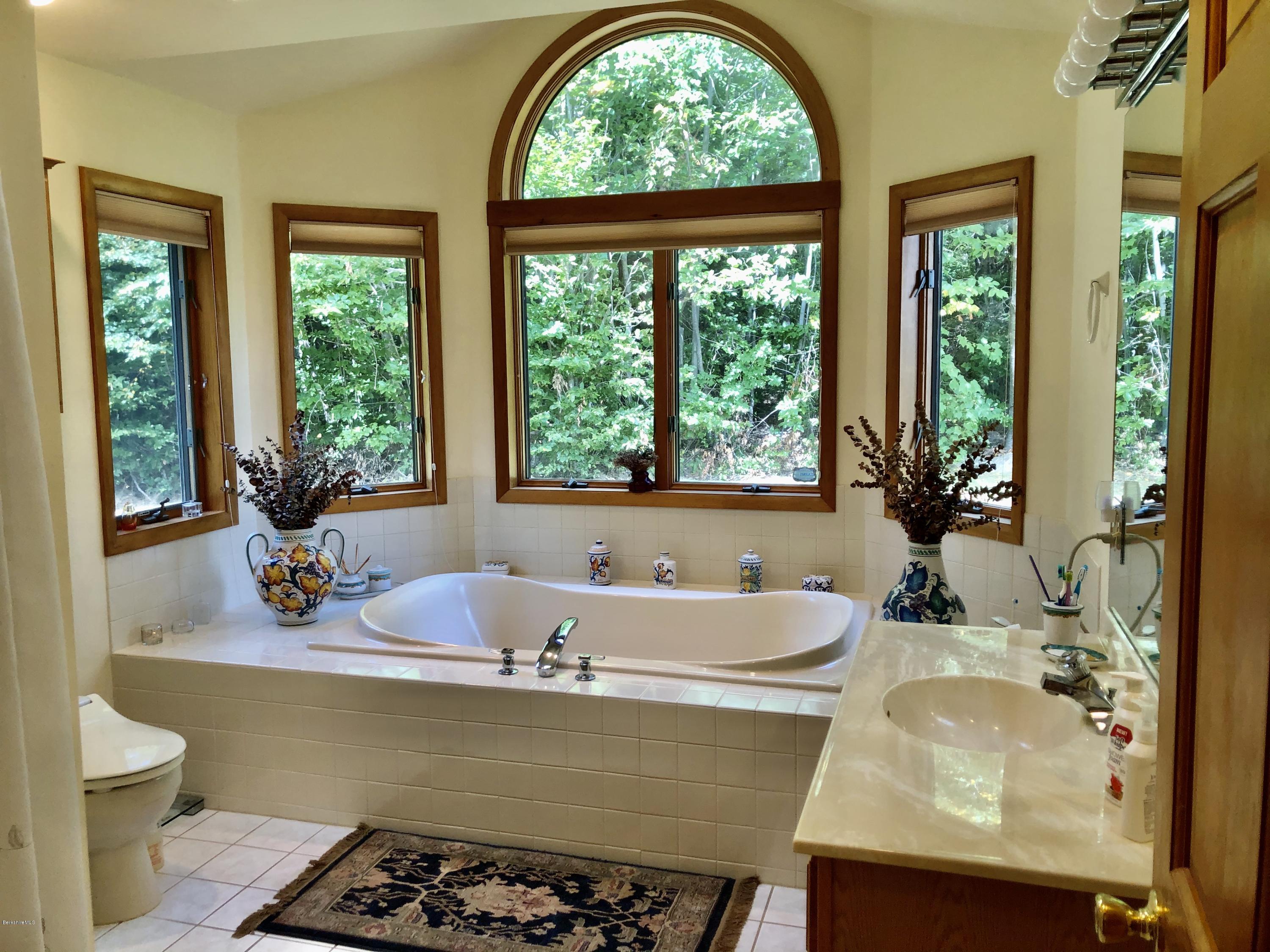 359 Harrington Road Otis, MA 01253 - Photo 27 of 60 a bath tub sitting in a bathroom next to a window