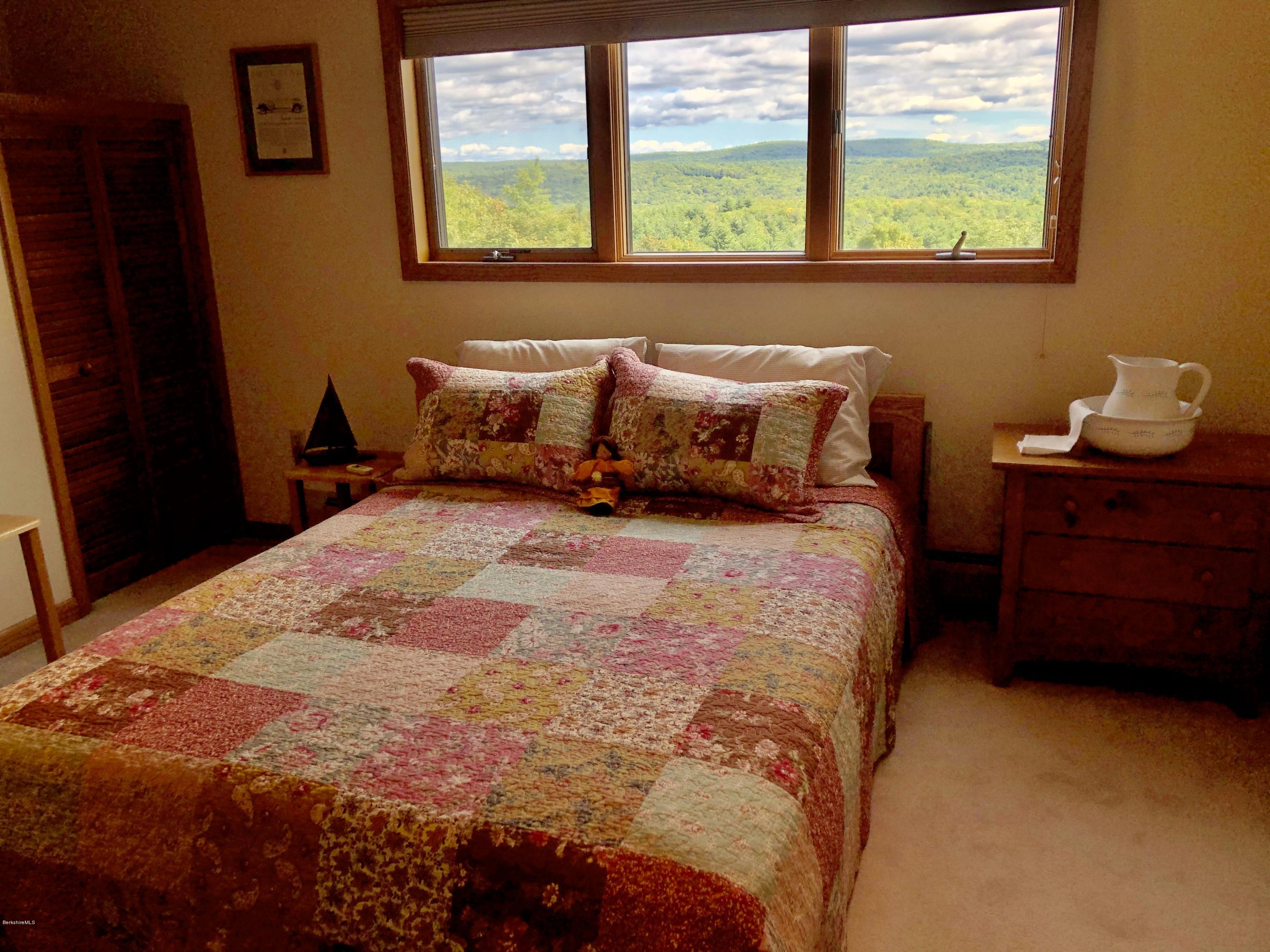 359 Harrington Road Otis, MA 01253 - Photo 31 of 60 a bed sitting in a bedroom next to a window
