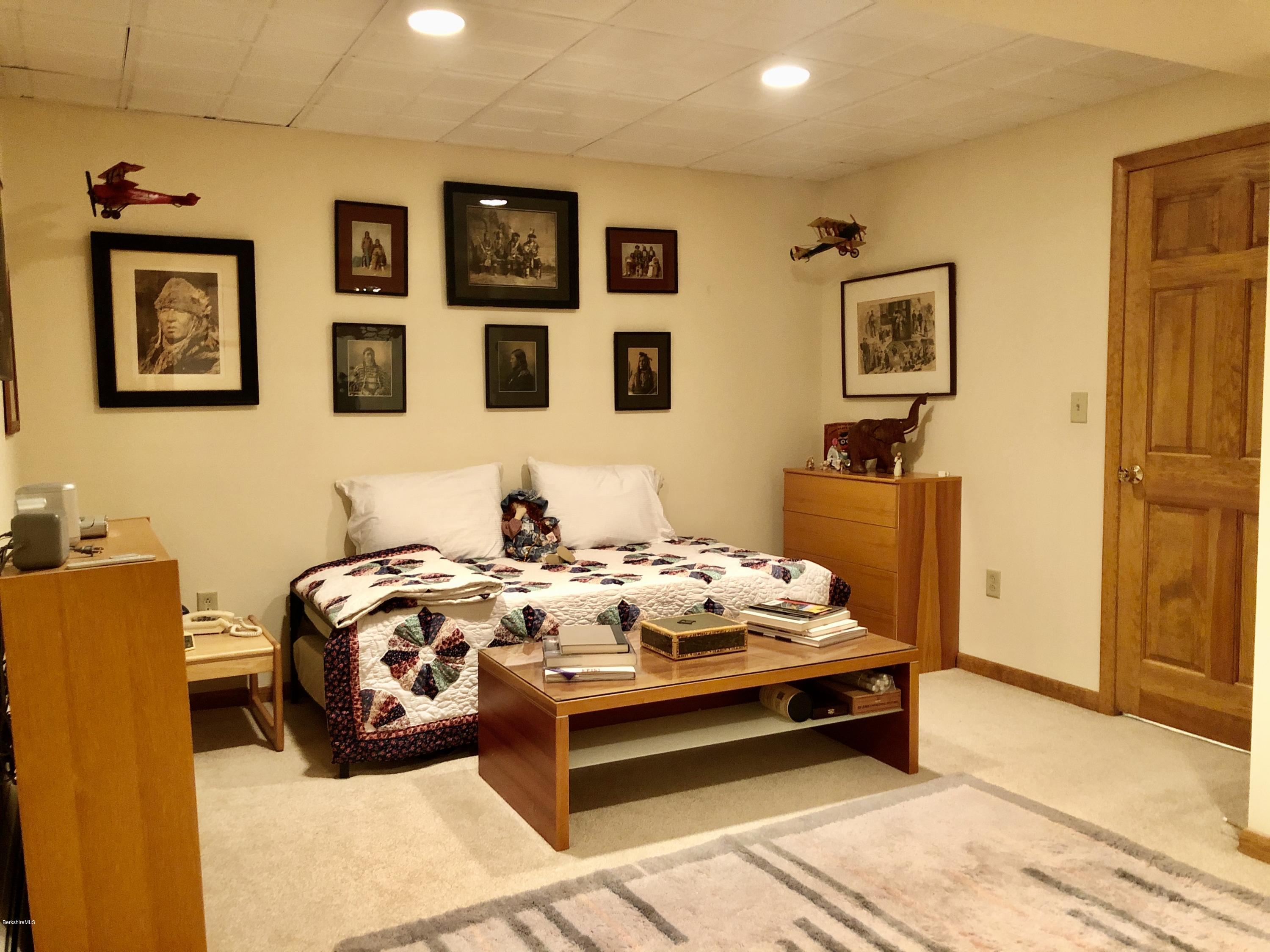 359 Harrington Road Otis, MA 01253 - Photo 39 of 60 a bedroom with bed and wall paintings