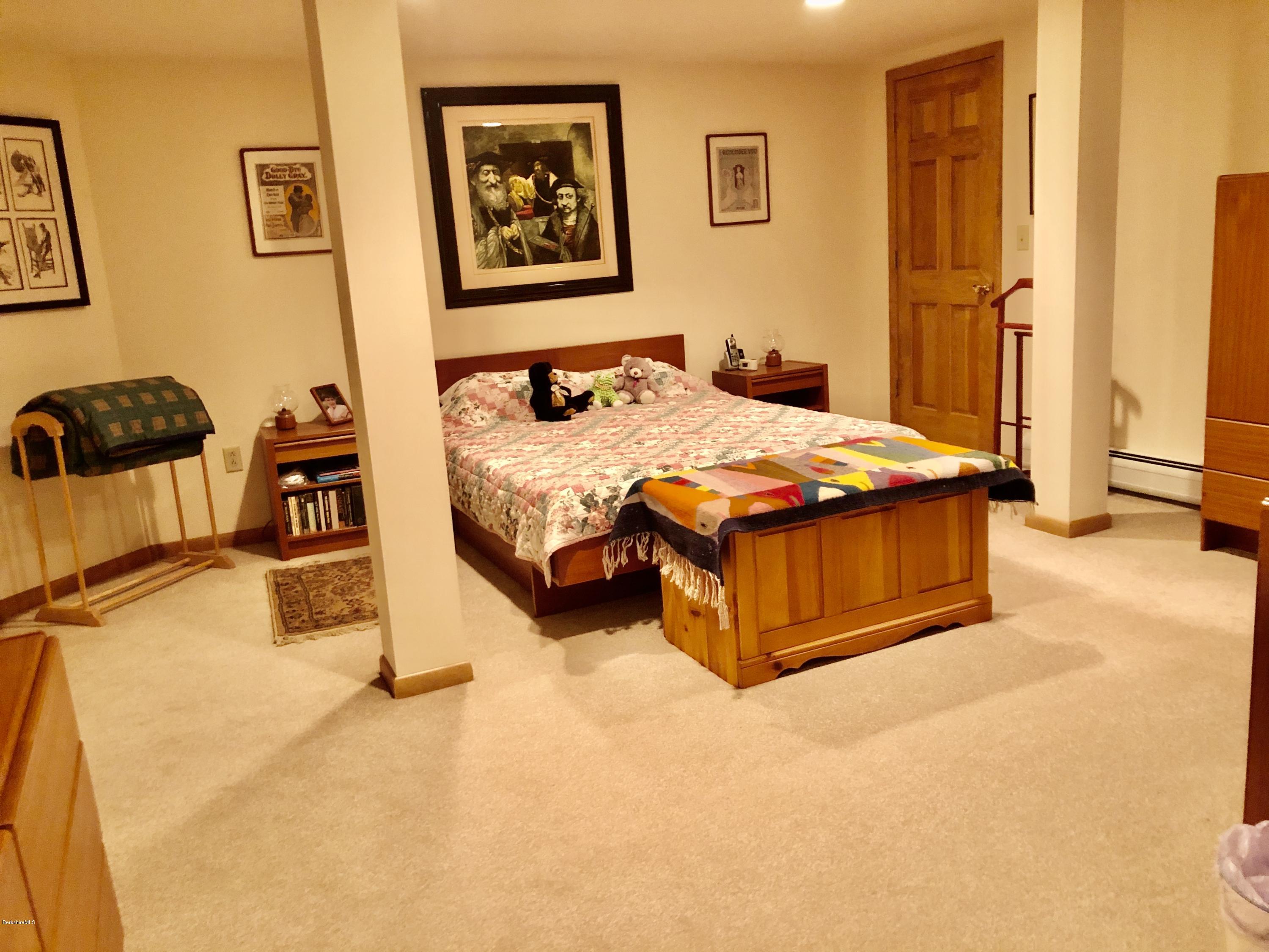 359 Harrington Road Otis, MA 01253 - Photo 41 of 60 a bedroom with bed and wall painting