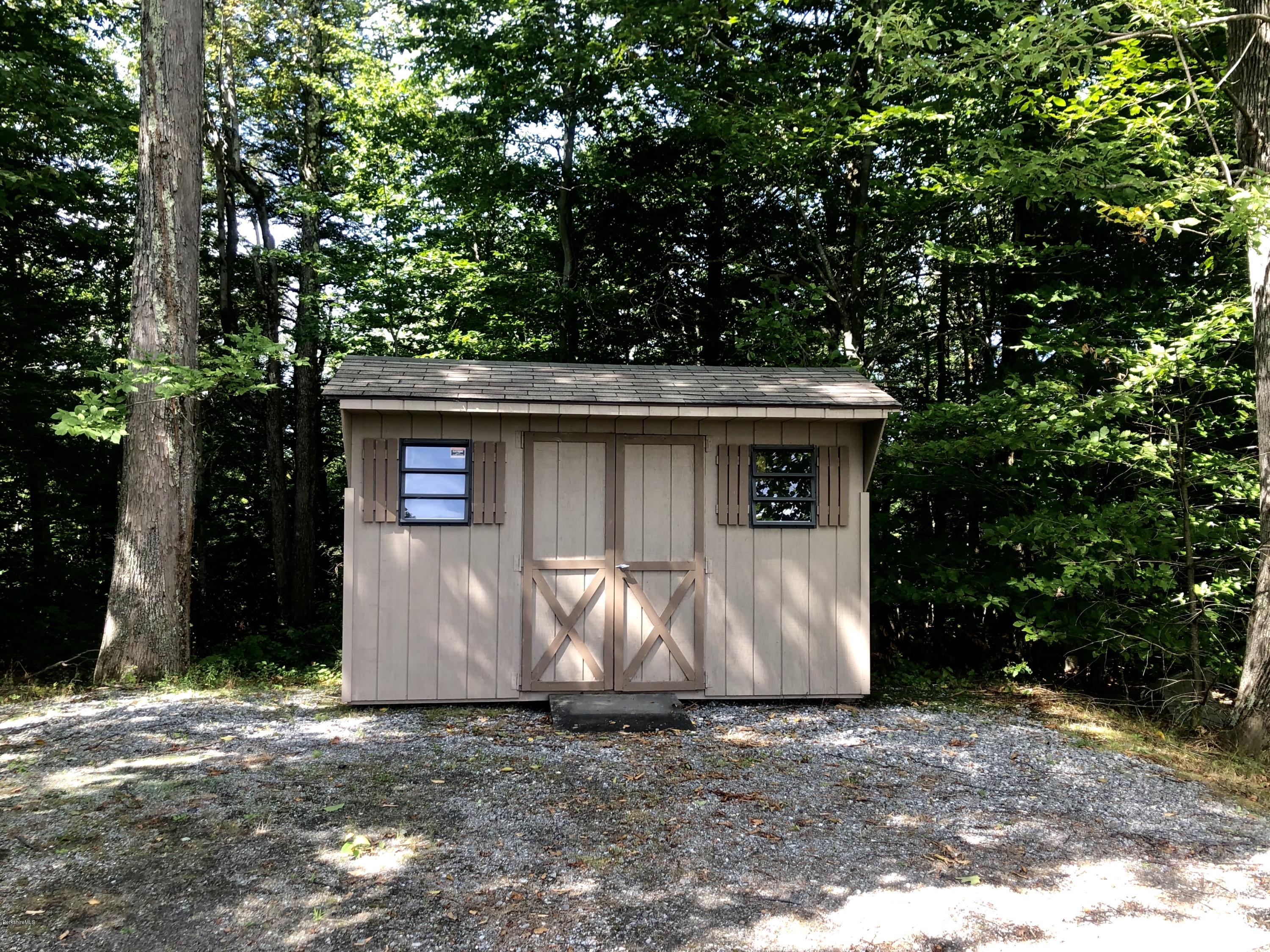 359 Harrington Road Otis, MA 01253 - Photo 58 of 60 a front view of a house with parking space