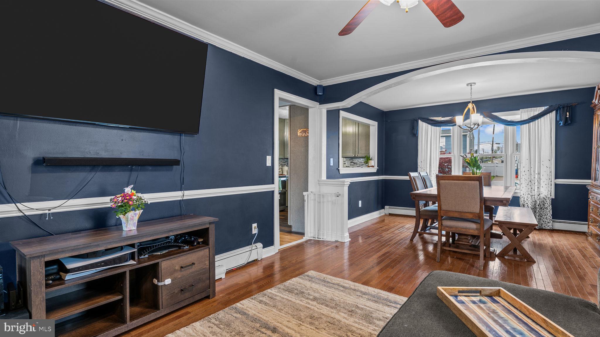 55 Grapevine Road Levittown, PA 19057 - Photo 12 of 27 a living room with furniture a flat screen tv and kitchen view