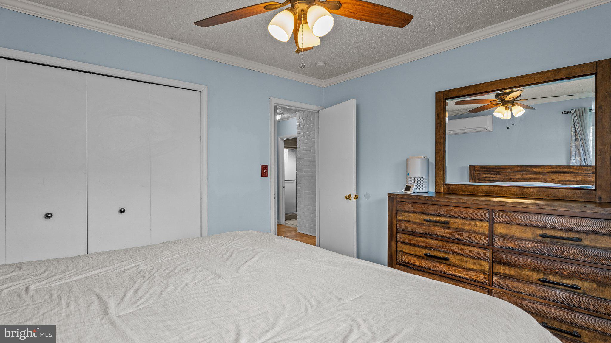 55 Grapevine Road Levittown, PA 19057 - Photo 14 of 27 a bedroom with a bed and a chandelier