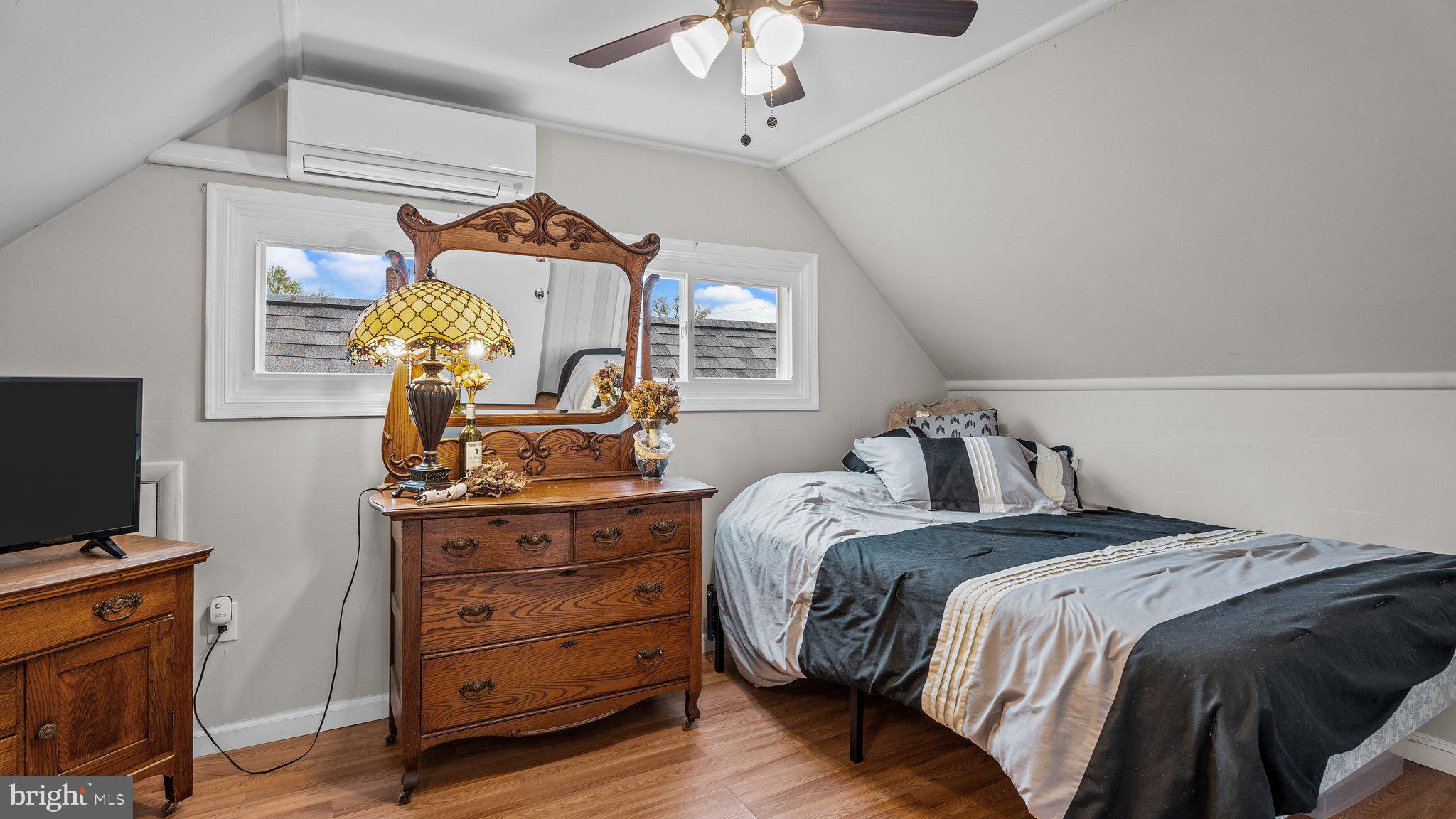 55 Grapevine Road Levittown, PA 19057 - Photo 23 of 27 a bedroom with a bed and a chandelier