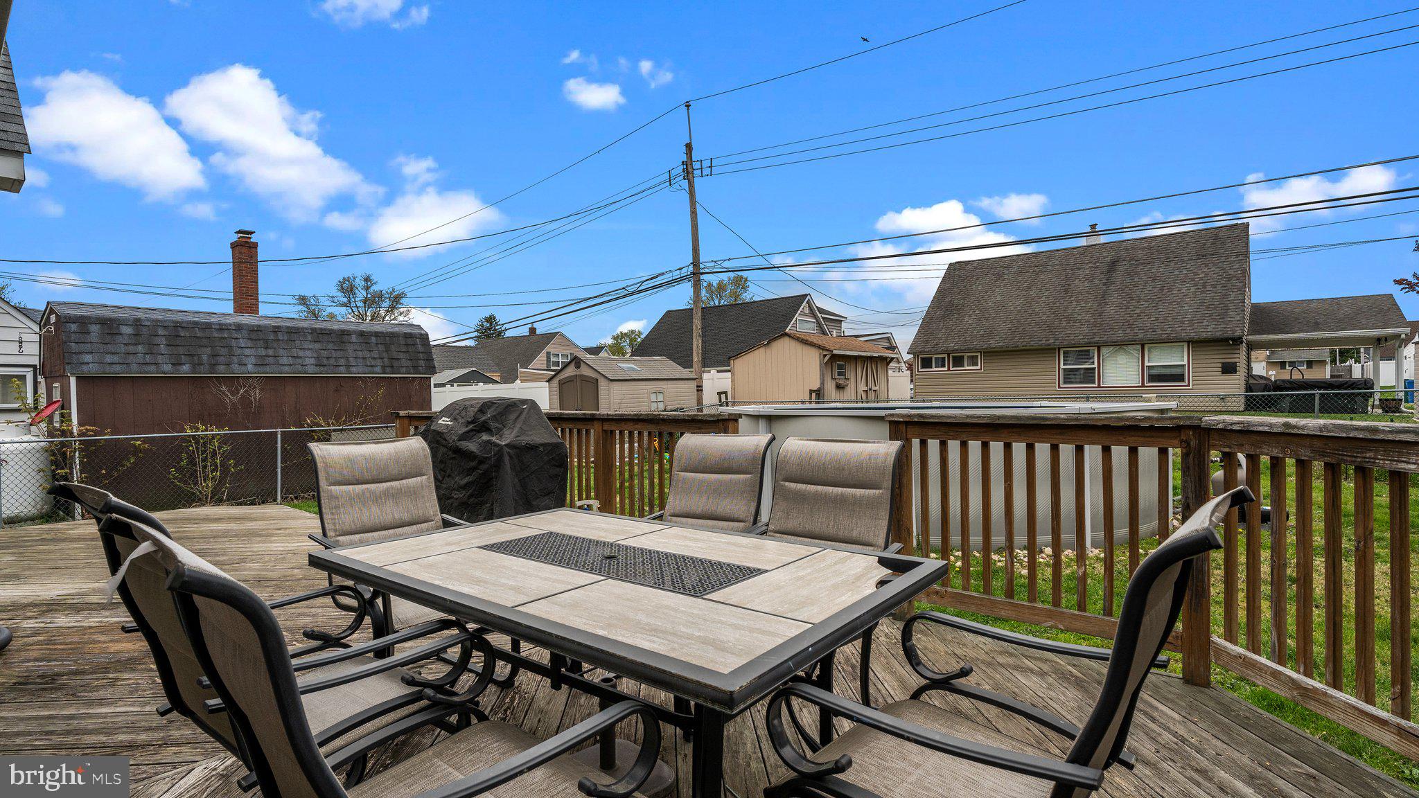 55 Grapevine Road Levittown, PA 19057 - Photo 24 of 27 a roof deck with a dining table and chairs with wooden floor