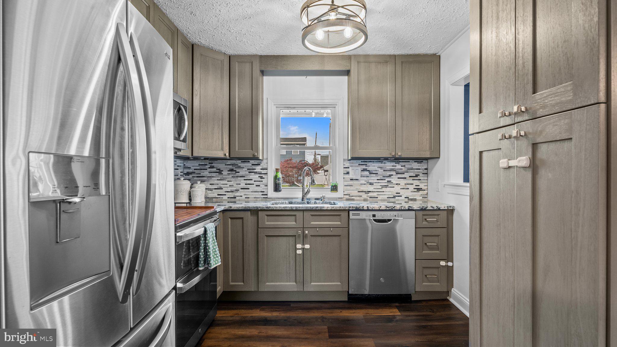 55 Grapevine Road Levittown, PA 19057 - Photo 3 of 27 a kitchen with stainless steel appliances granite countertop a refrigerator and a sink