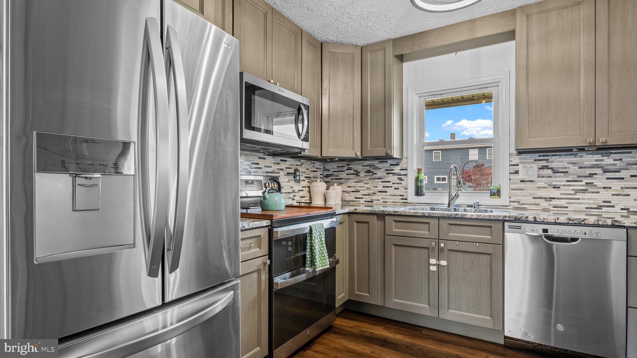 55 Grapevine Road Levittown, PA 19057 - Photo 4 of 27 a kitchen with stainless steel appliances granite countertop a refrigerator and a sink