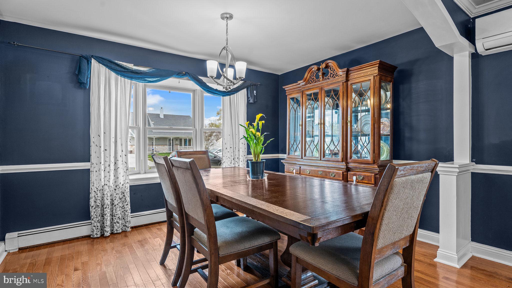 55 Grapevine Road Levittown, PA 19057 - Photo 8 of 27 a dining room with furniture a chandelier and wooden floor